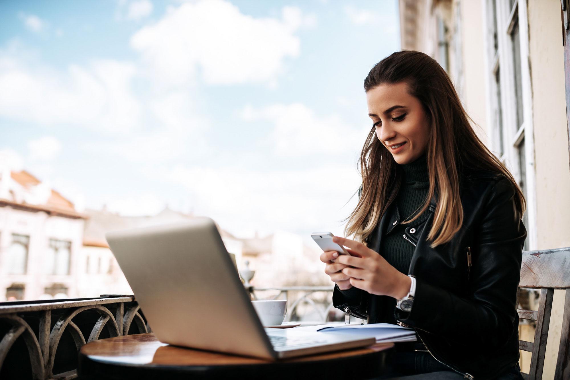 Professional sitting at a table with a laptop.